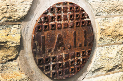 I don't know what those four letters stand for, but I wonder if this was some kind of a seal, and if the first to letters stand for "Insane Asylum."