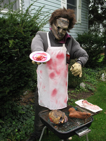 My grill guy, Leatherface.  I put him up every year, but his plate is new this year.  The grill looks cool at night; just a strand of red lights with lots of blinker bulbs in it to make different parts of it blink irregularly, making it look like coals.  I'm gonna hook a fog machine up to it this year for smoke.